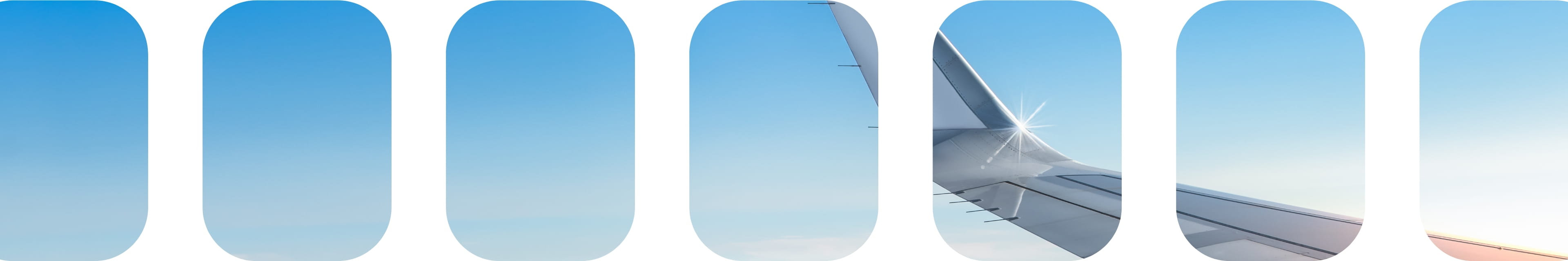 青空を背景に、飛行機の翼が写った画像